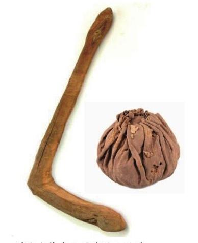 A photo of the ancient leather ball and polo stick found in the ancient yanghai tombs in turpan